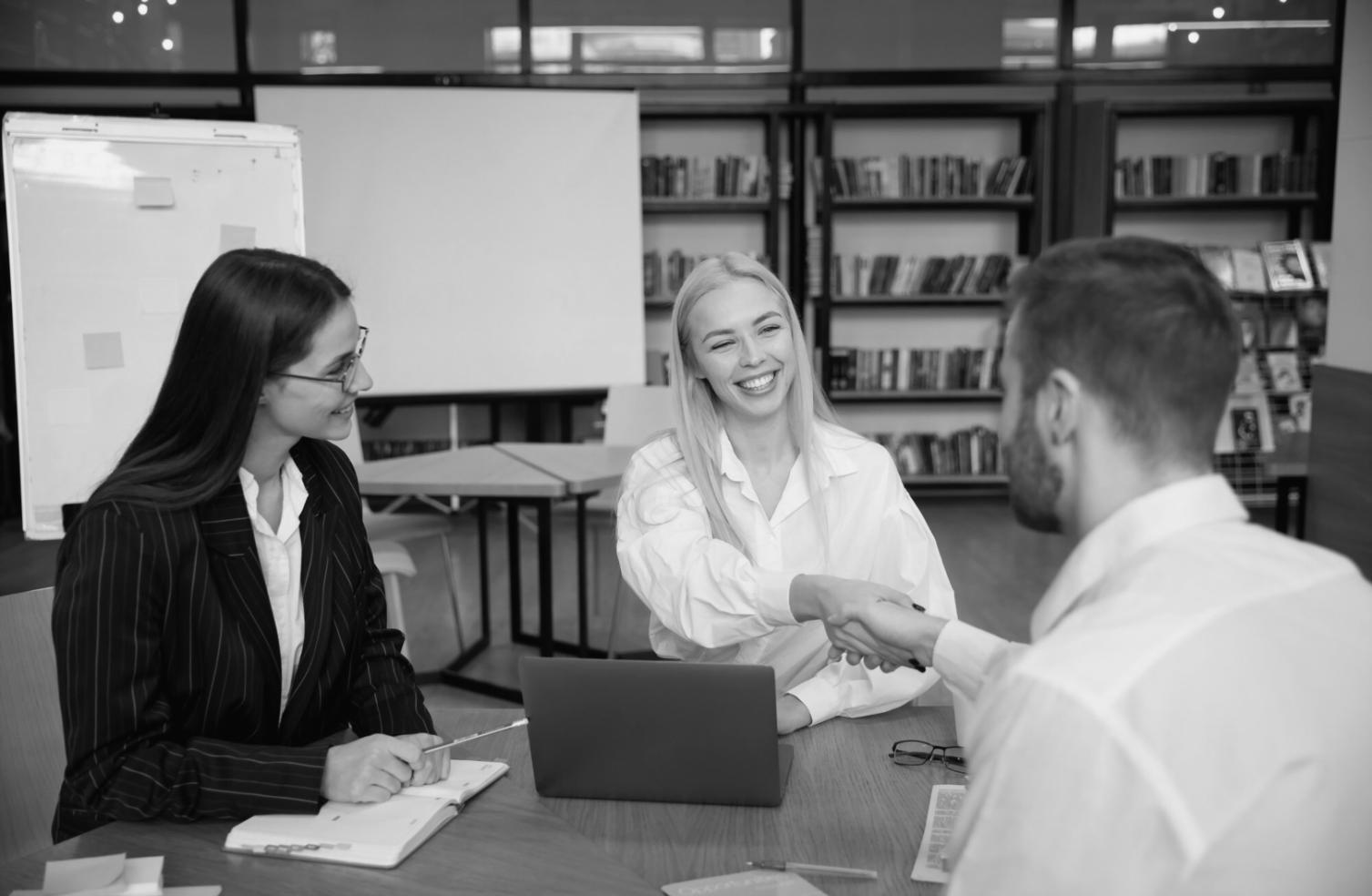Financial analysts working with comparative market data and charts in a modern Buenos Aires office environment